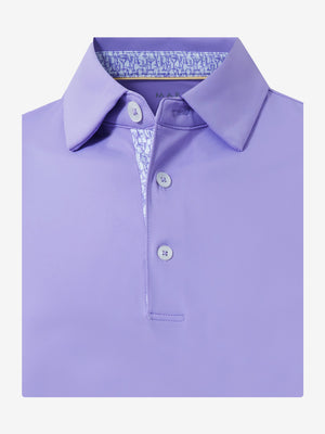Flat lay of the folded lilac everyday classic solid polo, showcasing the neat silhouette and solid color design