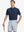 Model in NAVY Jacquard Polo posing with golf club — active and athletic on the front view