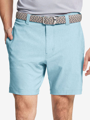 Front view of youth wearing sky blue Heather Performance Golf Shorts, showing fit and style
