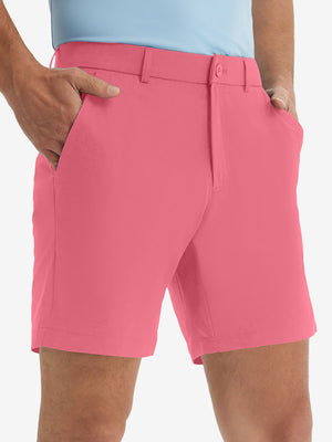 Front lower body shot of model wearing the peach pink stretch soft flat front dress golf shorts, showcasing the fit