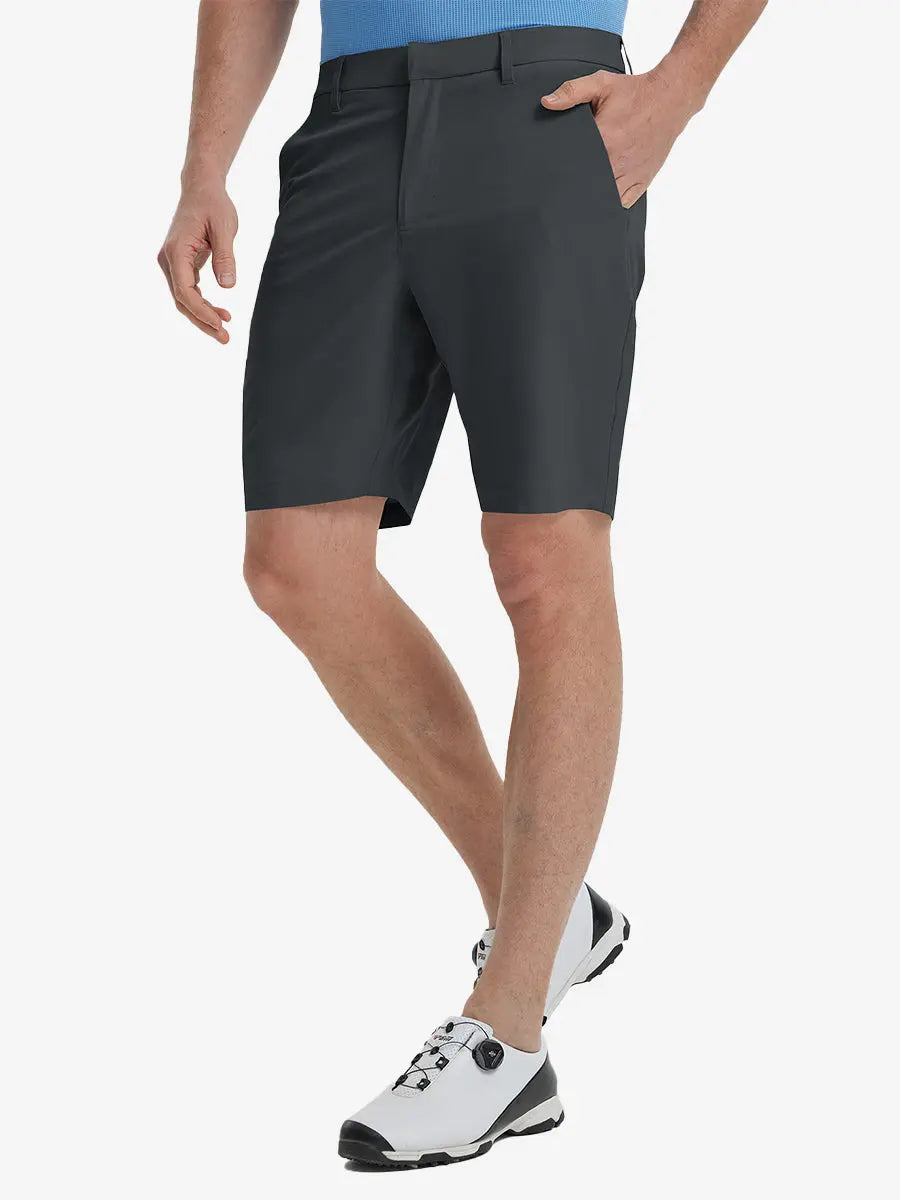 Front view of model’s lower body with hands in pockets, wearing Player Fit Versatile Solid Shorts 9 Inch – DARK GREY