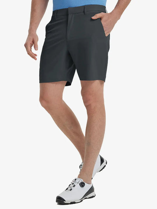 Front view of model’s lower body with hands in pockets, wearing Player Fit Versatile Solid Shorts 7 Inch – DARK GREY