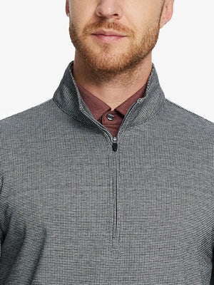 Front half-body view from nose down of model wearing BLACK HOUNDSTOOTH Premium Jacquard Quarter Zip Pullover.								
