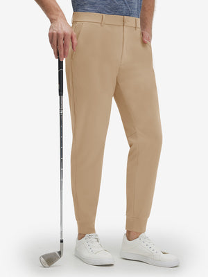 Front lower body shot of model wearing light khaki flat front golf joggers pants with belt loops