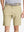 Front view of youth wearing khaki Heather Performance Golf Shorts, showing fit and style