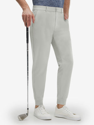 Front lower body shot of model wearing silver gray flat front golf joggers pants with belt loops