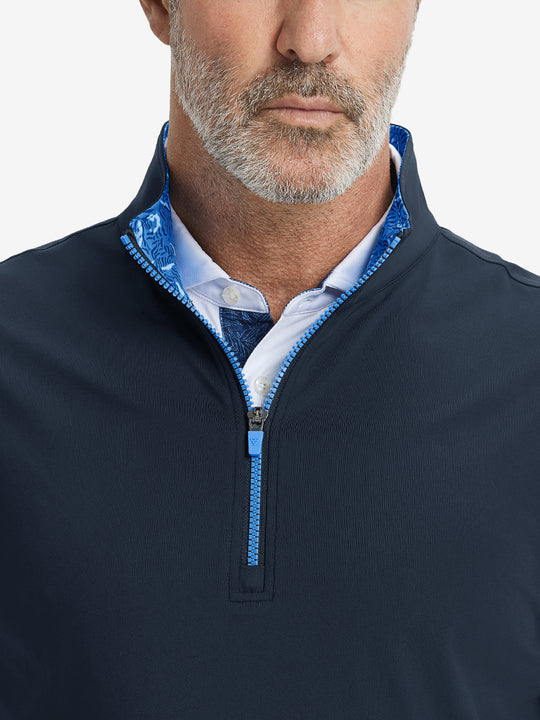 Close-up from nose to chest, showing collar detail and zipper of the navy golf vest.
