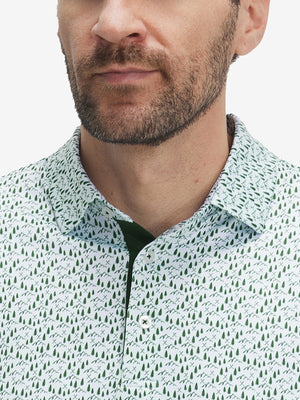 Front view from nose to chest of model wearing the green forest 4 way stretch print collared polo shirt, showcasing the upper fit
