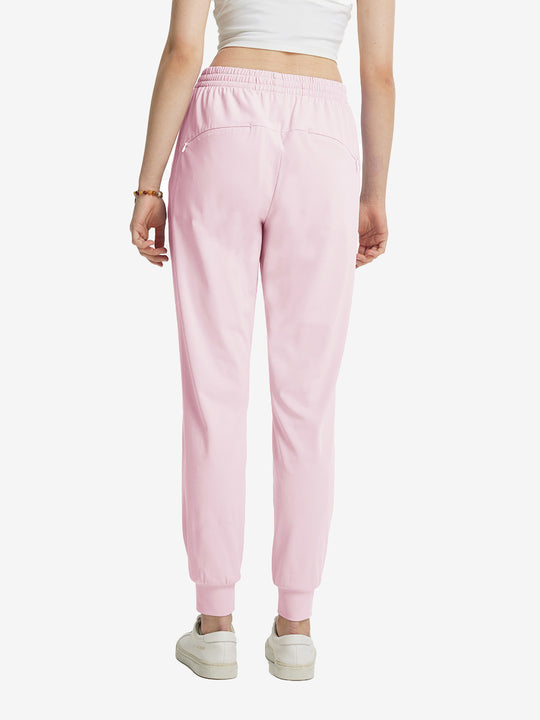 Back view of lightweight women's stretchy joggers sweatpants on model, shown in light purple.