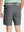 Back view of youth in dark grey Heather Performance Golf Shorts, highlighting rear design and fit