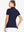 Back-side half-body shot of model in NAVY Women's Performance Solid Polo, looking over shoulder
