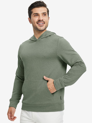 Model front view with one hand in side pocket wearing warm fleece golf hoodies pullover green.