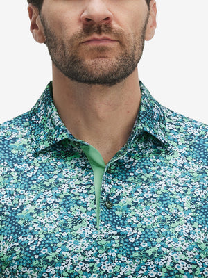 Close-up of lower face and upper shirt in Performance quick dry print golf polos, navy green floral detail
