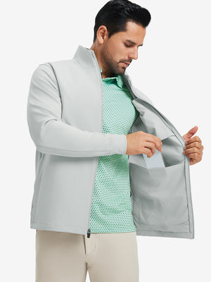 Model wearing water-resistant zip up golf jacket, silver grey, front upper-body with one hand in pocket.