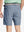 Back view of youth in dark blue Heather Performance Golf Shorts, highlighting rear design and fit