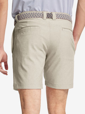 Back view of youth in cream Heather Performance Golf Shorts, highlighting rear design and fit