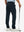Back lower-body view of lightweight moisture wicking dress pants, model with golf club in navy.
