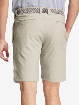 Back view of youth in cream Heather Performance Golf Shorts, highlighting rear design and fit