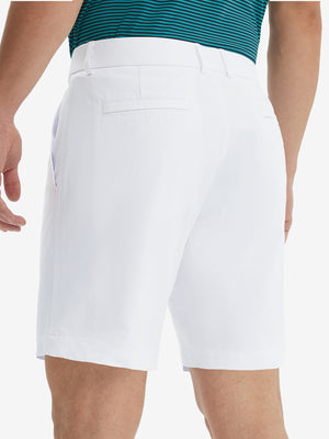 Back lower body view of model wearing the white stretch soft flat front dress golf shorts, highlighting the rear design