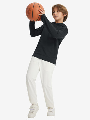 Full-body view of model holding basketball, wearing youth long sleeve hoodied with kangaroo pocket in black.