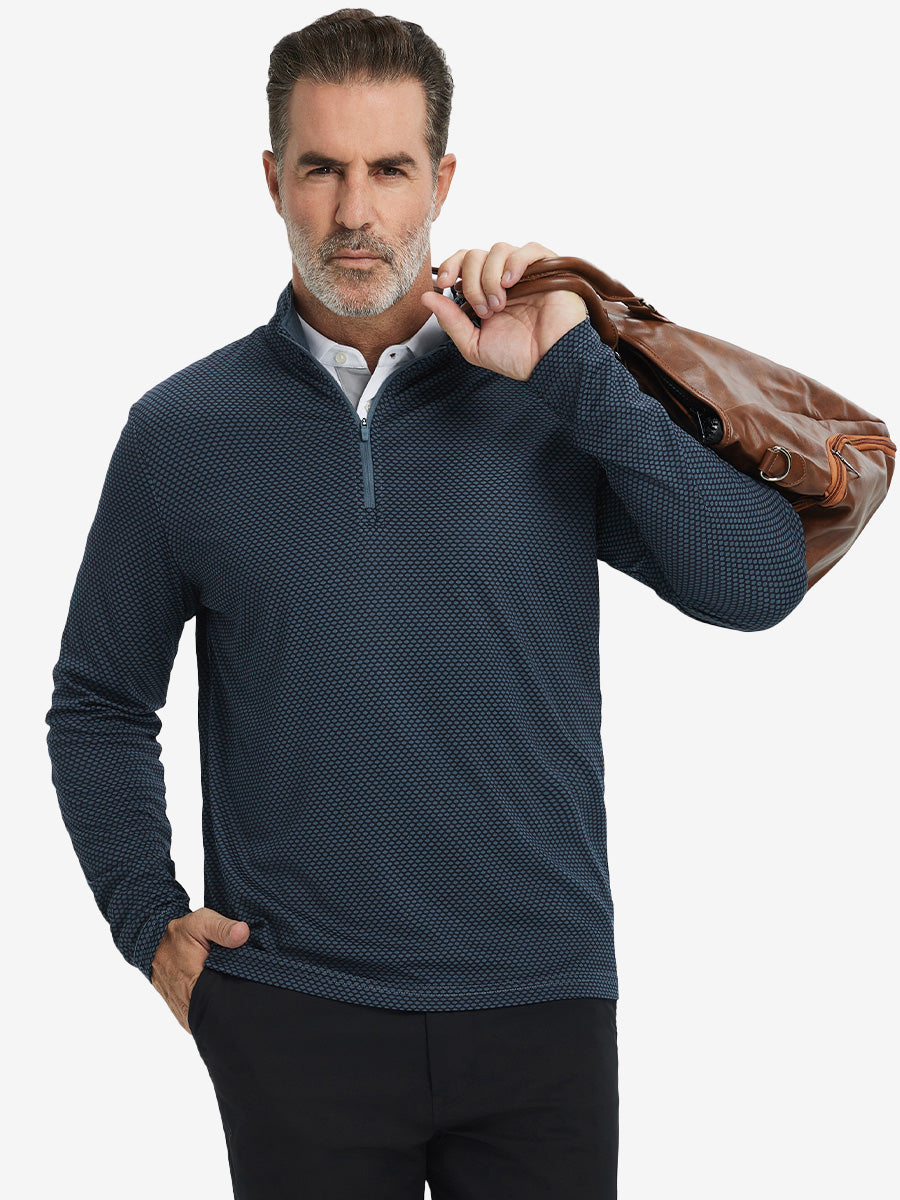 Model carrying a golf bag in jacquard quarter zip pullover in grey/navy, blending comfort and style.