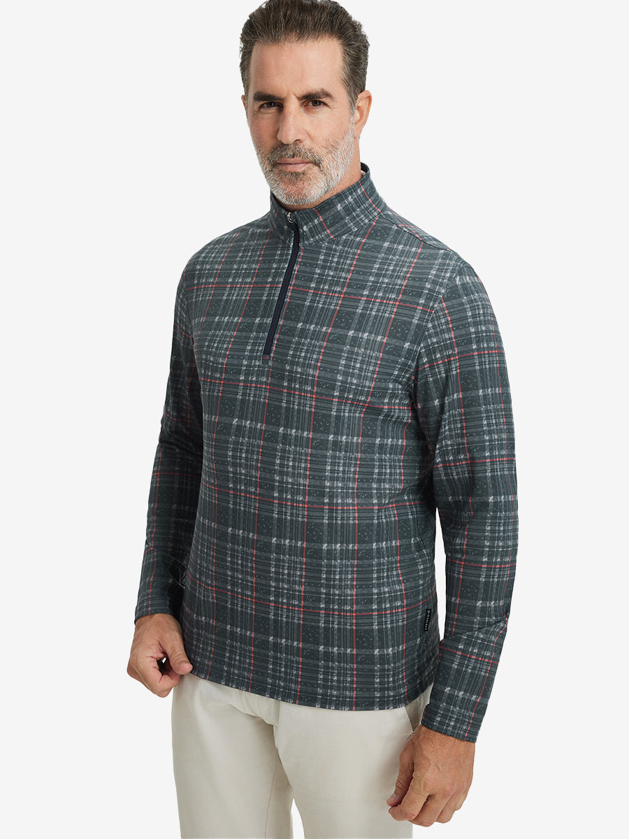 Front upper body view of model standing in retro black/red plaid full print quarter zip pullover, relaxed look.