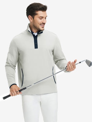 Model holding golf club, wearing mock neck quarter button golf pullover in silver gray, sporty look.