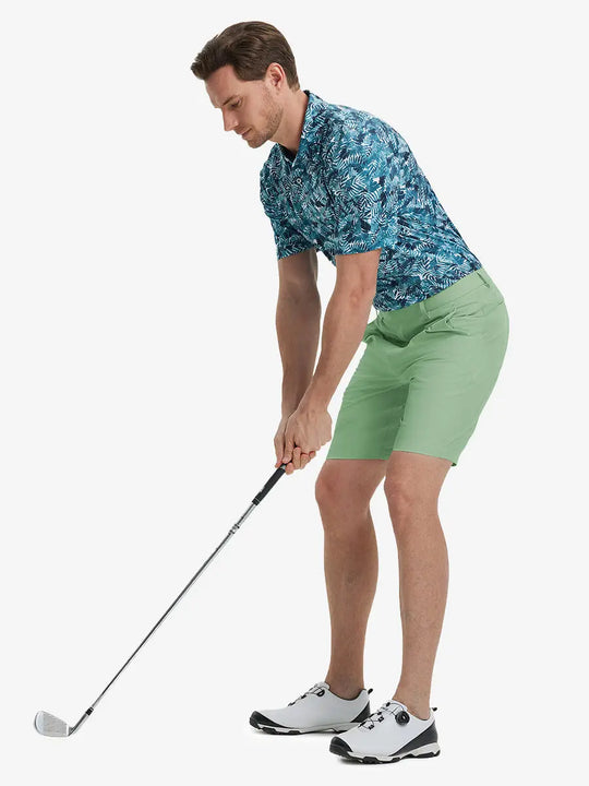 Full-body front shot of model holding golf club, wearing Player Fit Versatile Solid Shorts 9 Inch – BERYL GREEN