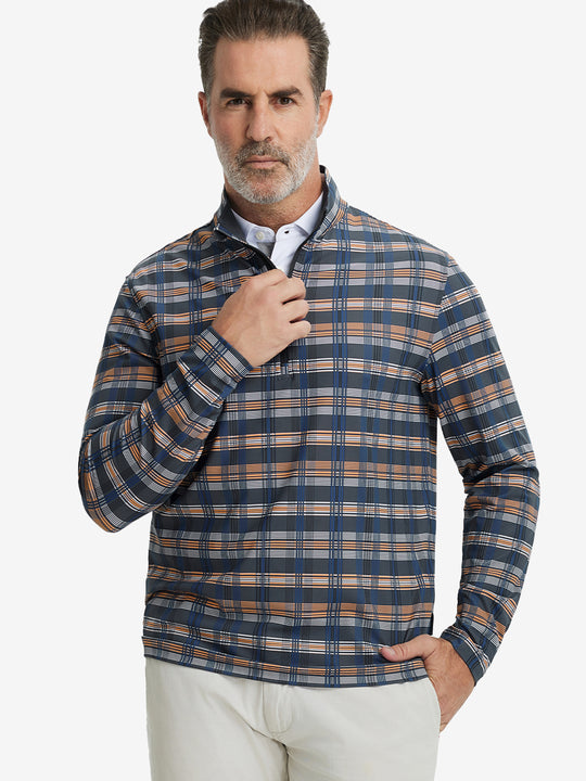 Front upper body view of model standing in blue/white/yellow plaid full print quarter zip pullover, relaxed look.