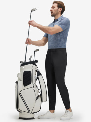 Front full body shot of model wearing black flat front golf joggers pants with belt loops