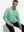 Model sitting and wearing jacquard quarter zip pullover in light green, showing relaxed casual posture.