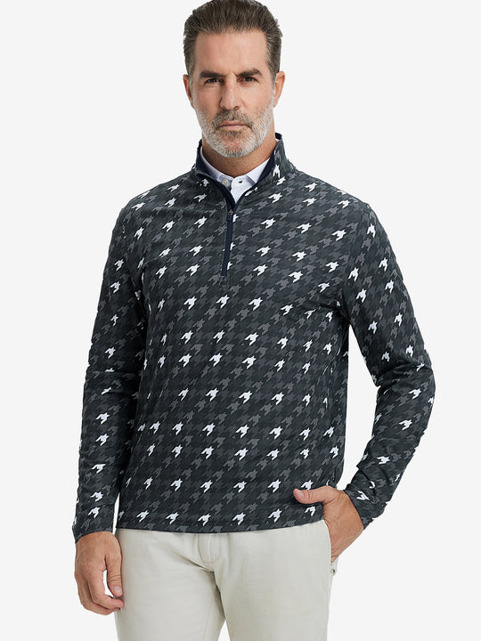 Front upper body view of model standing in grey houndstooth full print quarter zip pullover, relaxed look.