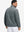 Back view of the model in the reversible fleece jacket with 5 pockets in dark grey.