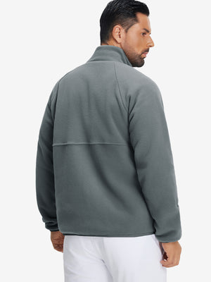 Back view of the model in the reversible fleece jacket with 5 pockets in dark grey.