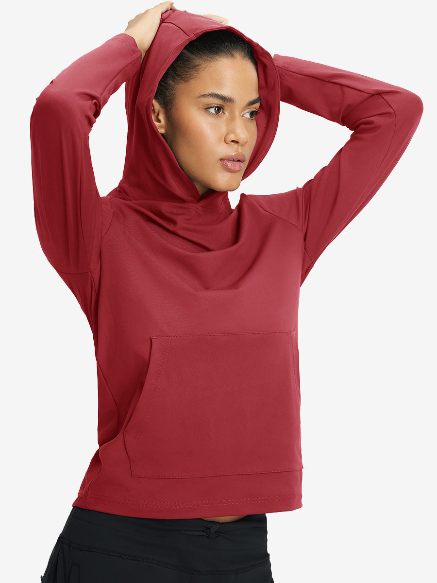 Model holding hoodie cap with both hands, wearing women's lightweight hoodies pullover in red.