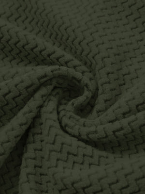 Fabric close-up of warm stretchy quarter zip with pocket, smooth knit texture and flexible feel in forest forest green