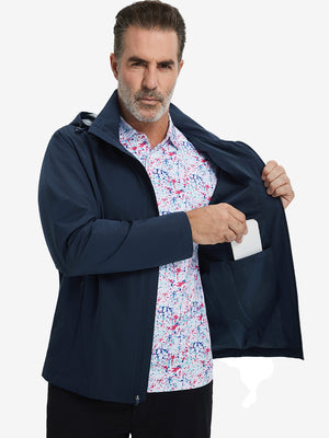 Model placing an iPhone into the inner pocket of the lightweight water-repellent softshell hooded jacket in navy.