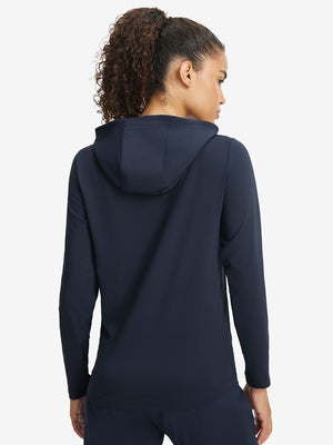 Back upper view of model in women's lightweight hoodies pullover, showing relaxed fit in navy.