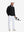 Model carrying golf bag in Fleece lined golf quarter zip with versatile black look