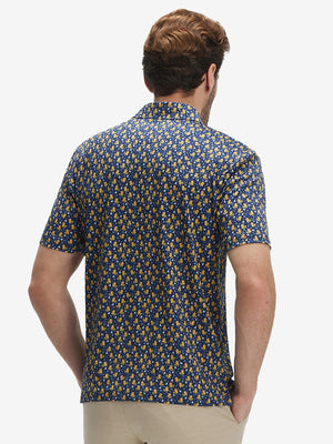 Back half-body view of model wearing the yellow duck 4 way stretch print collared polo shirt, highlighting the rear silhouette