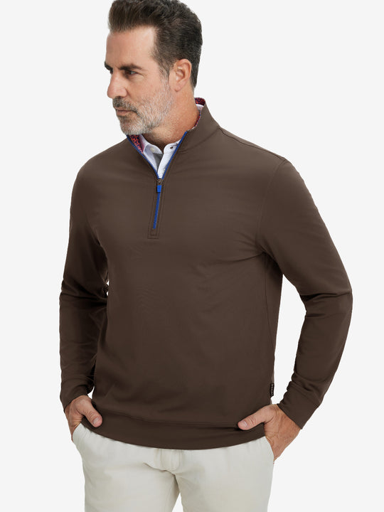 Front upper body view of model wearing lightweight golf quarter zip pullover in coffee brown, relaxed fit.