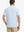 Back view of model in Slate Blue Aqua Blue Stripe Performance Stripe Golf Shirt