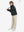 Model holding a racket, wearing black boys windproof puffer jacket with pockets in full-body view.