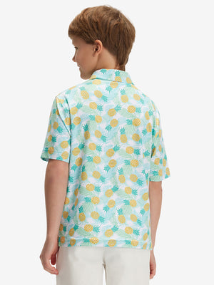Back half-body of boy in leaves pineapple performance print boys golf polo