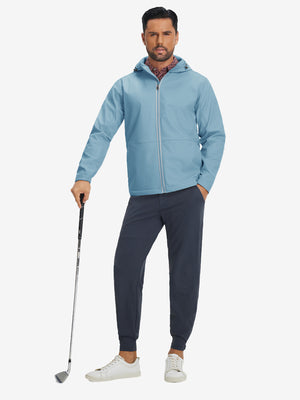 Model holding a golf club, wearing misty blue reflective hooded softshell jacket in full-body view.