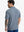 Back half-body view of model in GRAYISH BLUE FLOWER Popular Heather Print Polo