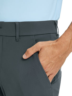 Close-up detail of one hand resting in pocket, showing relaxed fit of the dark grey quick dry pants.