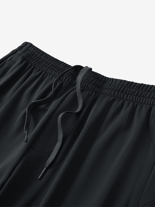 Angled view of lightweight women's stretchy joggers sweatpants waistband displayed in black.