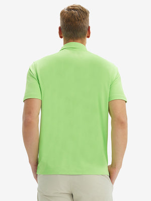 Back half-body view of model wearing the turquoise green ventilated pique performance polo, highlighting the rear silhouette