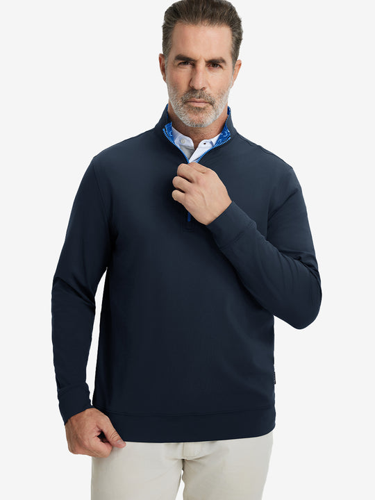 Front upper body view of model wearing lightweight golf quarter zip pullover in navy, relaxed fit.